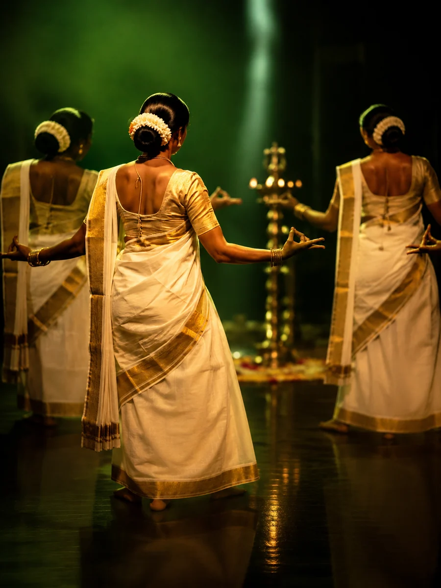 Women in white and gold kasavu dancing in a circle around a lit brass lamp